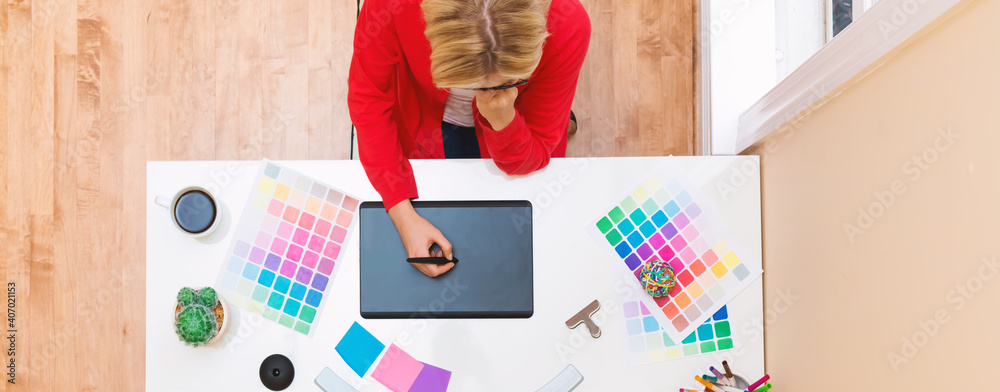 Graphic designer using her graphic tablet in an office