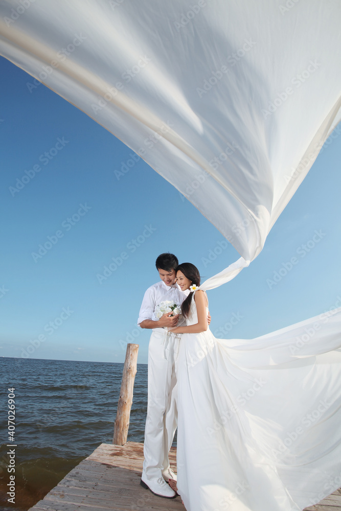 Young Couple in Wedding Dress on beach