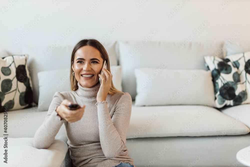 Sitting in the living room, sofa in the background.