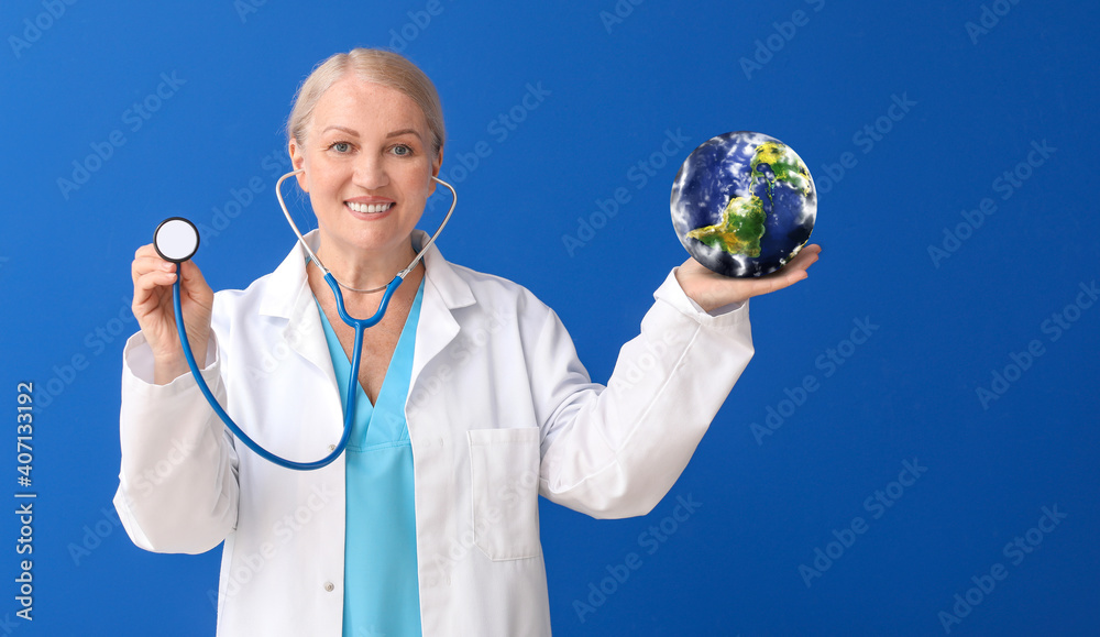 Female doctor with stethoscope and model of Earth on color background. Ecology concept