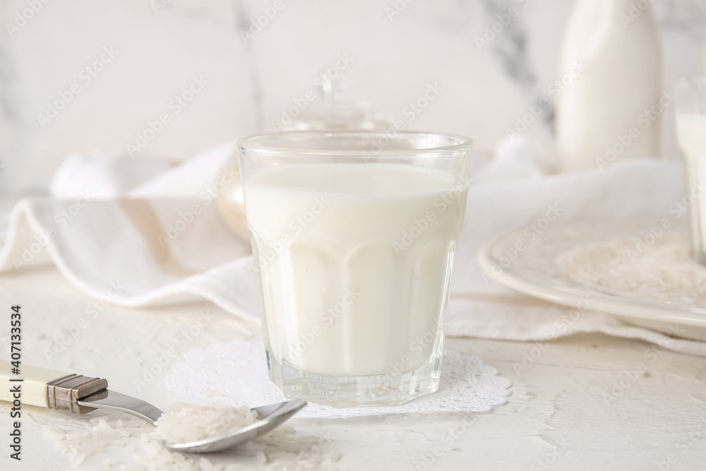 Glass of rice milk on table