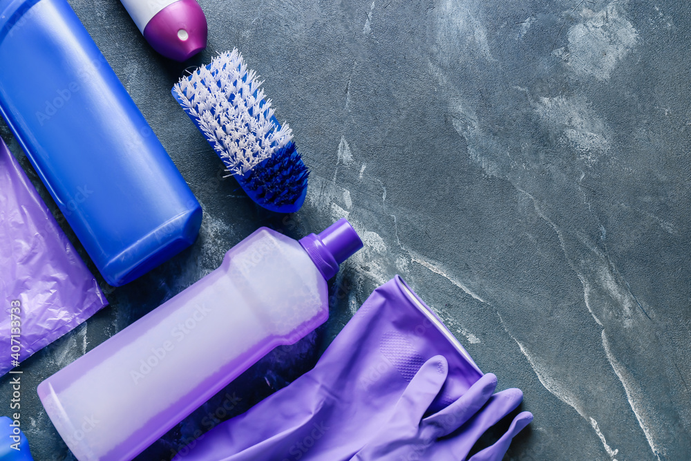 Set of cleaning supplies on dark background