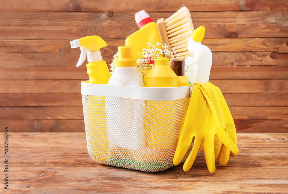 Set of cleaning supplies on wooden background