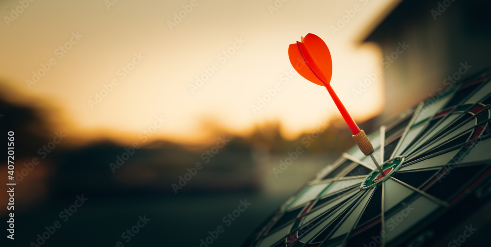 bullseye target or dart board has red dart arrow throw hitting the center of a shooting for business