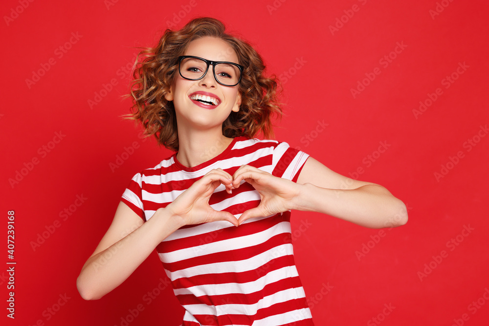 Happy young female gesturing heart