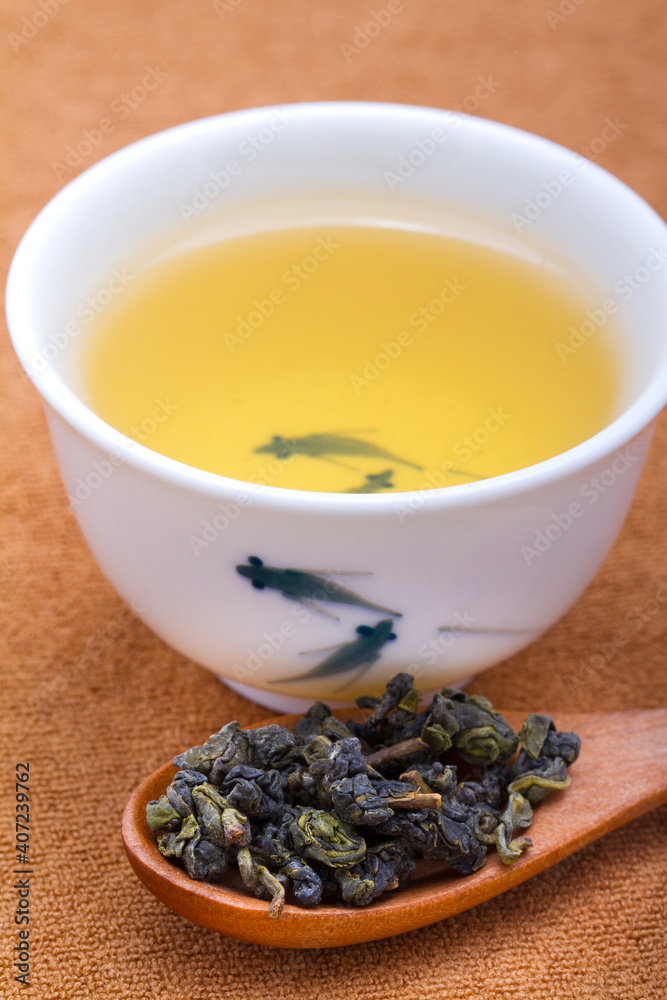 A cup of oolong tea with dried tea leaves,close-up