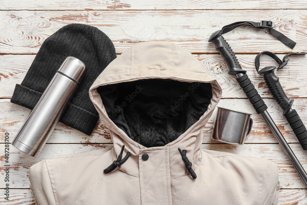 Equipment for hiking on wooden background