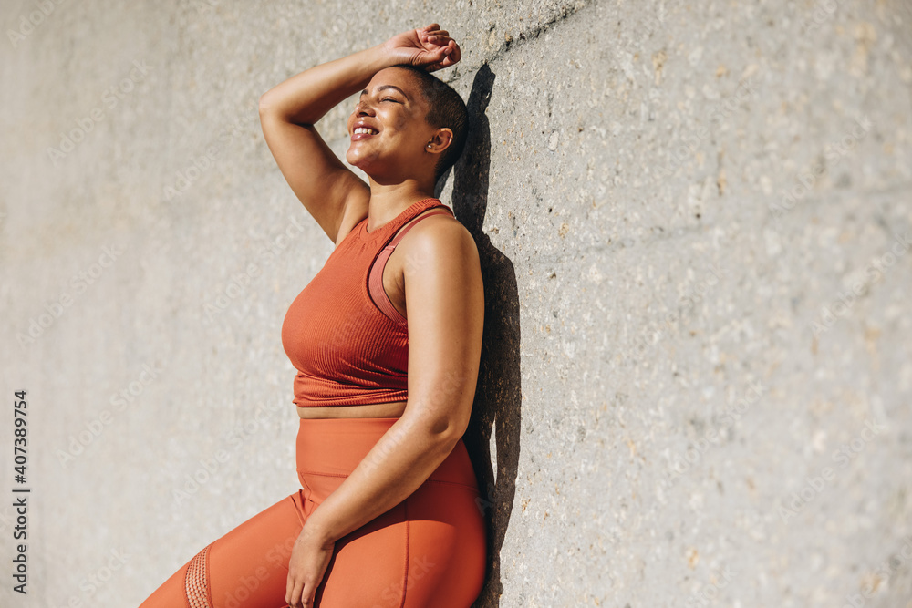 Healthy woman taking break from workout and relaxing