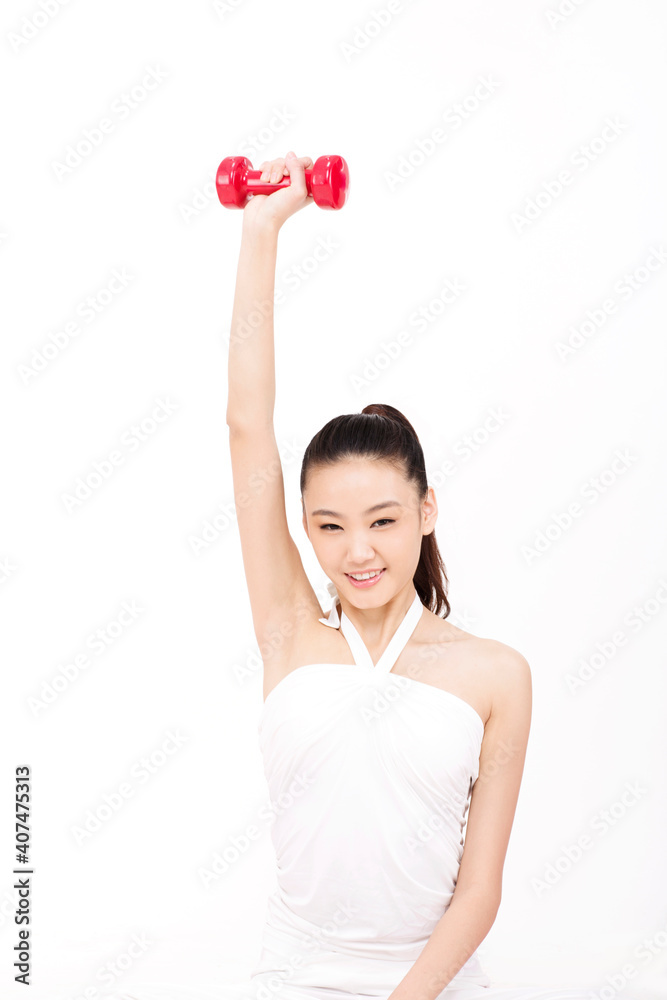 Young woman holding a dumbbell