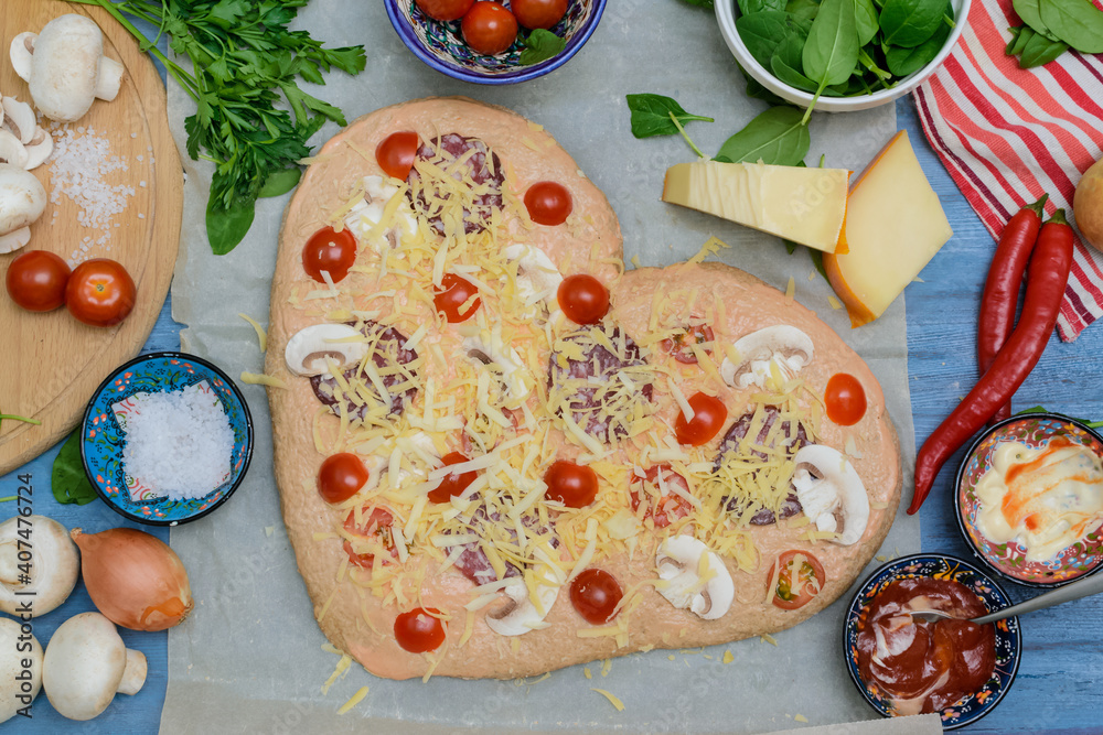 Homemade pizza for Valentines Day.Delicious pizza heart made of yeast-free dough with healthy veget