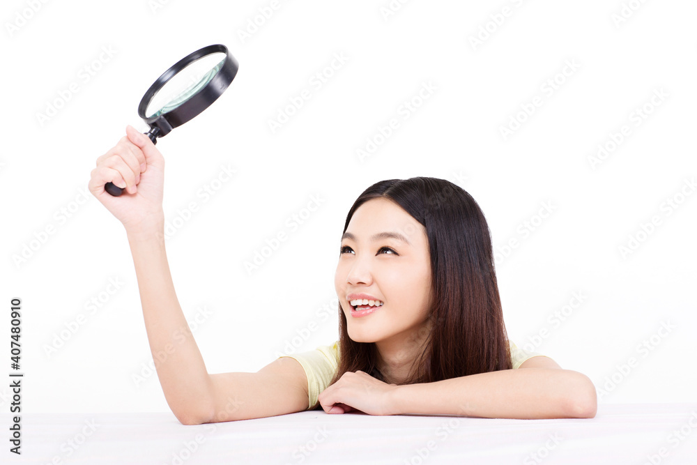 Young woman holding a magnifying glass