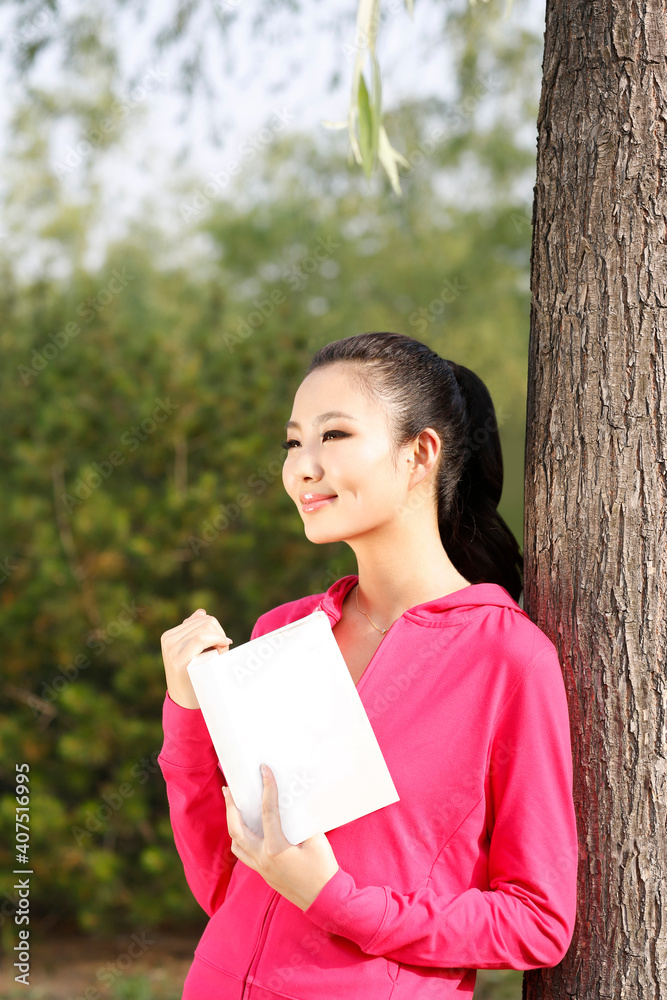 年轻女子在户外看书