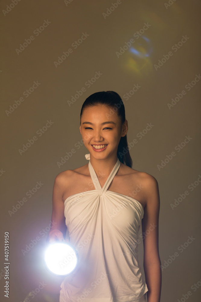 Young woman holding a flashlight