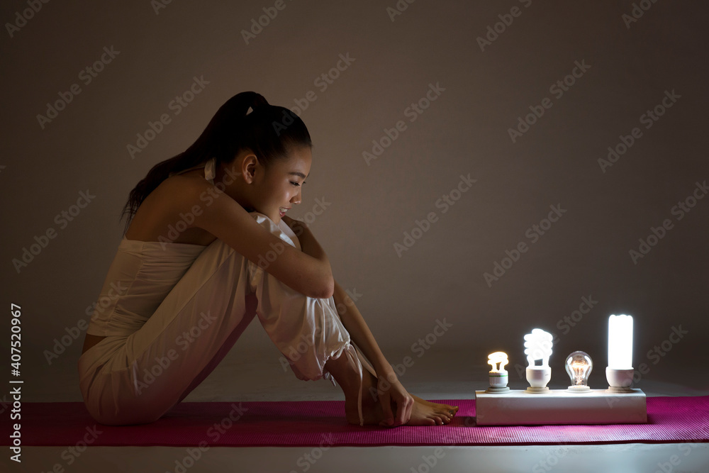 Young woman and a light bulb