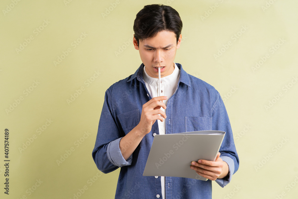 Photo of thinking handsome Asian businessman