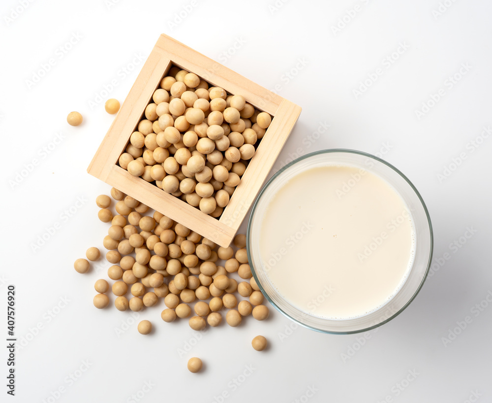 Soy milk and soybeans in a glass placed on a white background