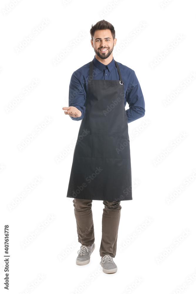 Young man wearing apron on white background