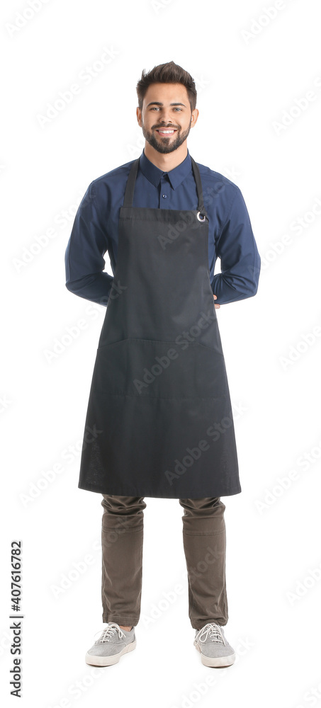 Young man wearing apron on white background