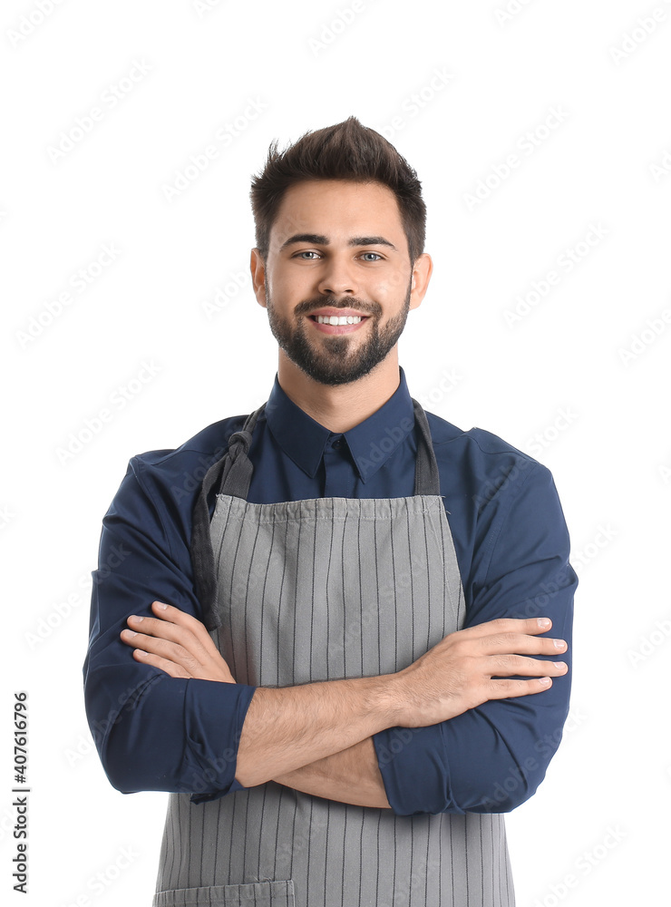 Young man wearing apron on white background