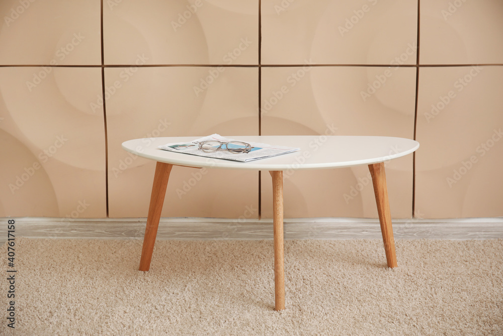 Stylish table near wall in room