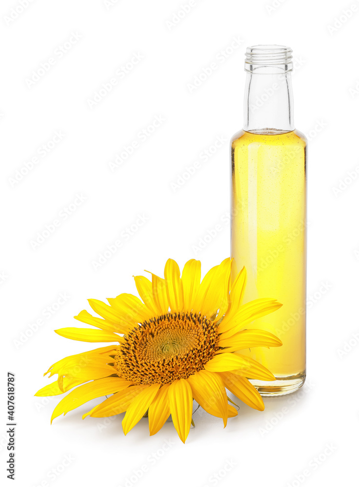 Bottle of oil and sunflower on white background