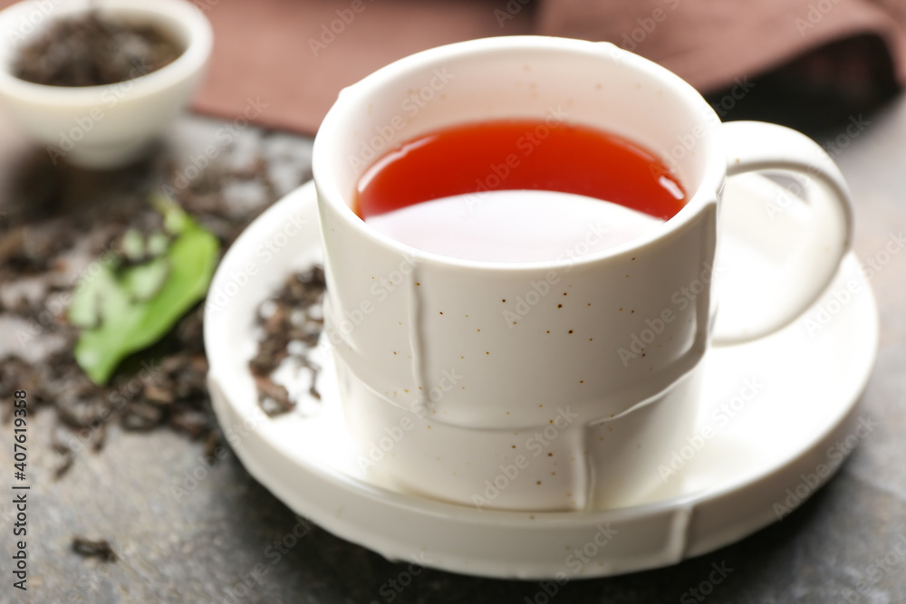 Cup of hot black tea on table