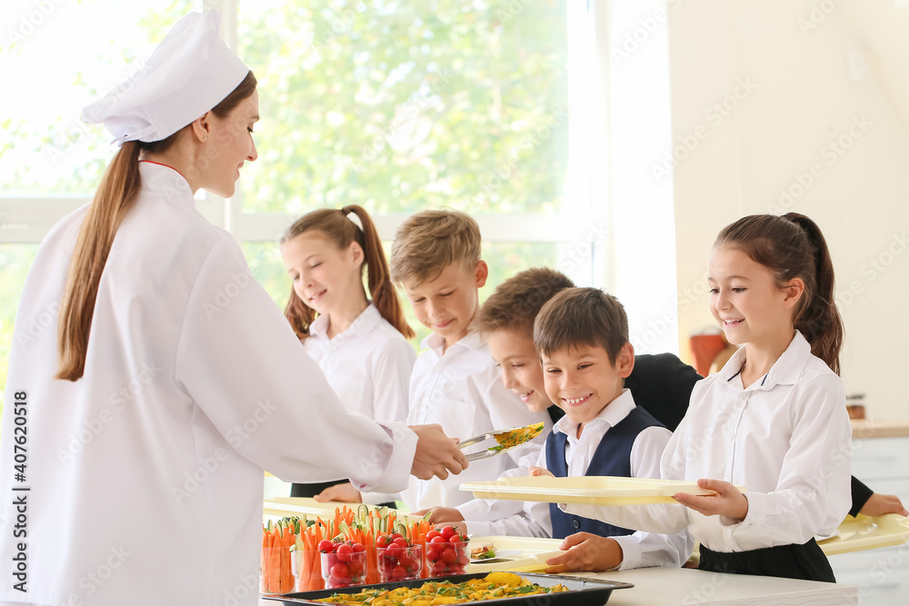 Pupils receiving lunch in school canteen