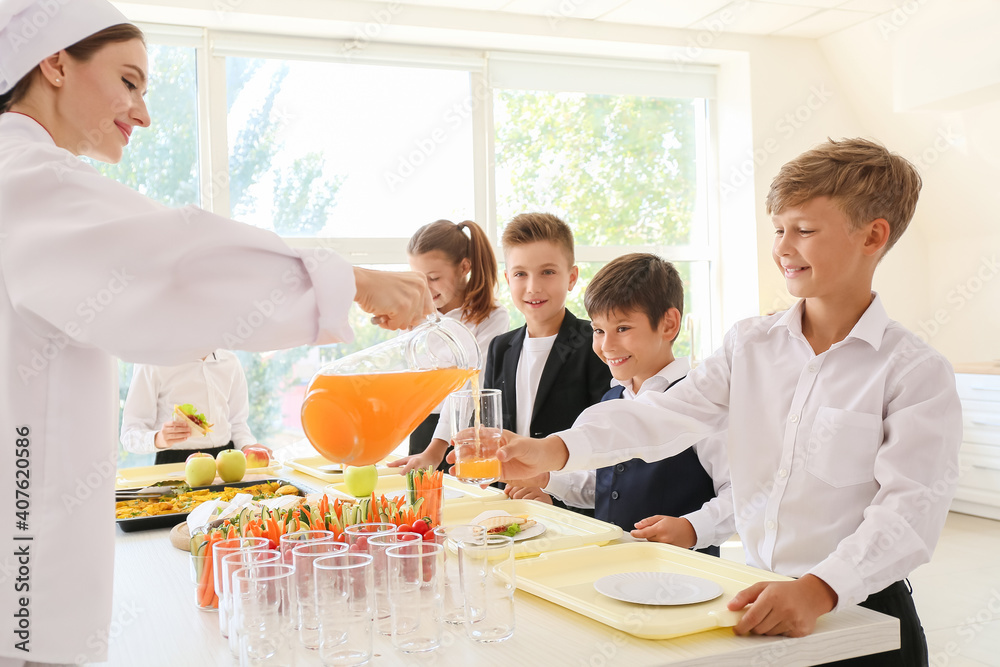 Pupils receiving lunch in school canteen