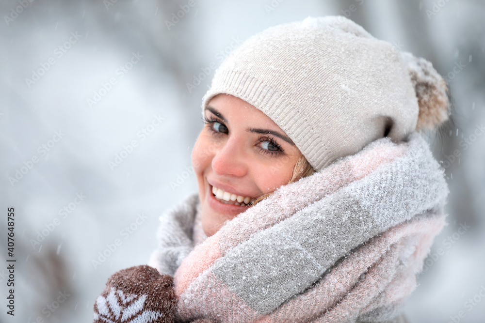 Beautiful woman in wintertime among snow