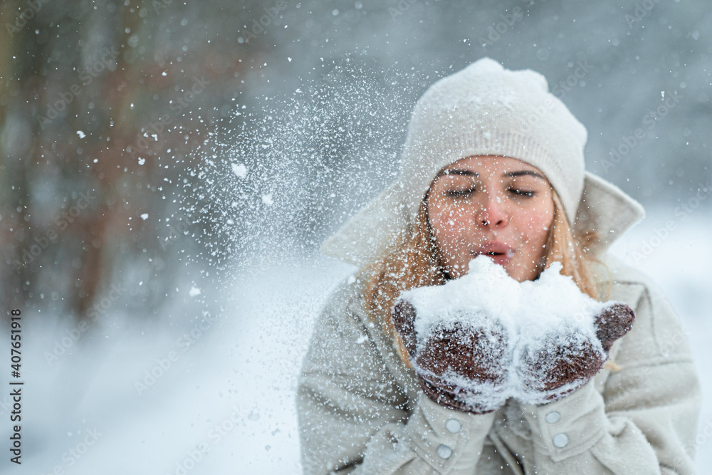 Happy girl playing with snow outdoor