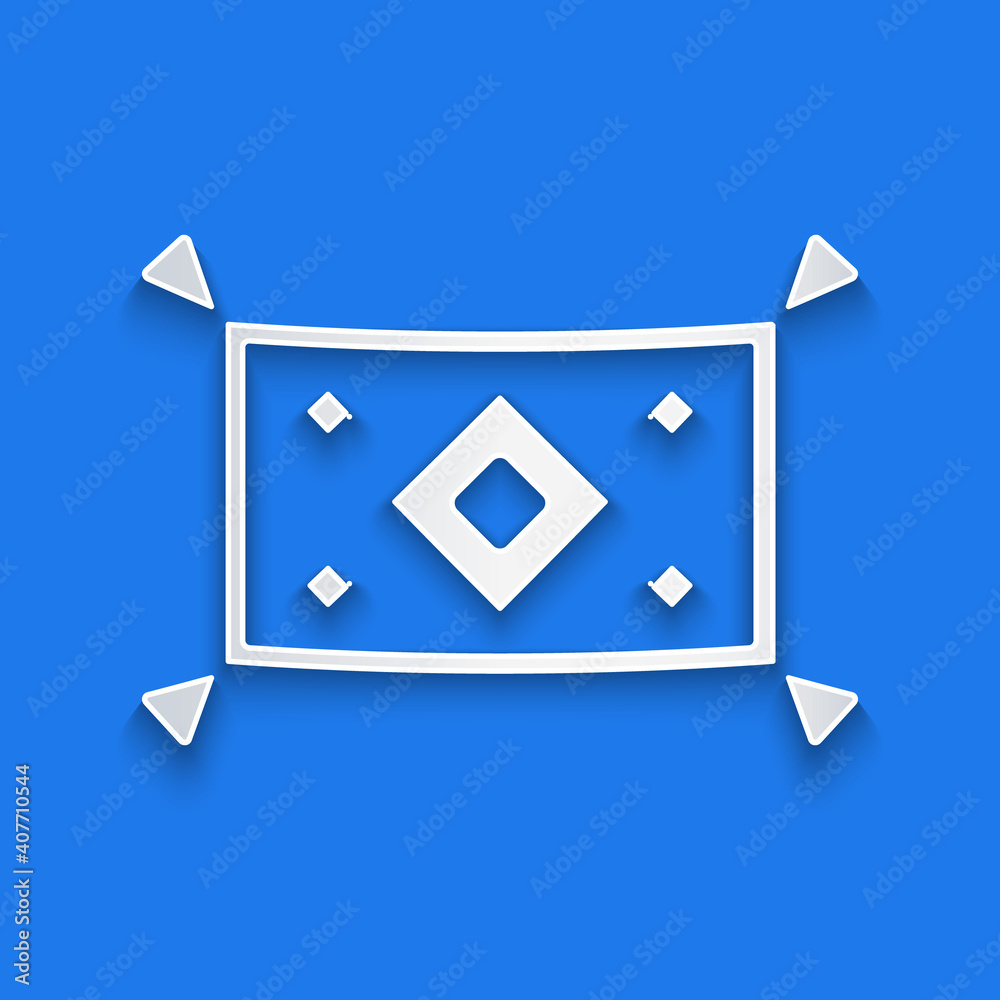 Paper cut Magic carpet icon isolated on blue background. Paper art style. Vector.