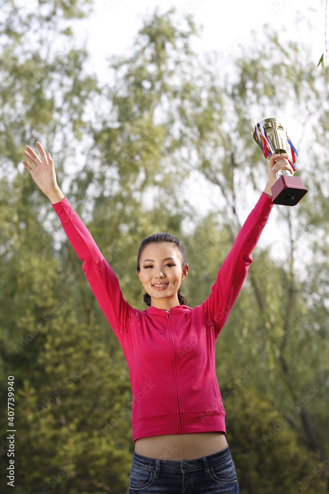 Young woman holding a trophy