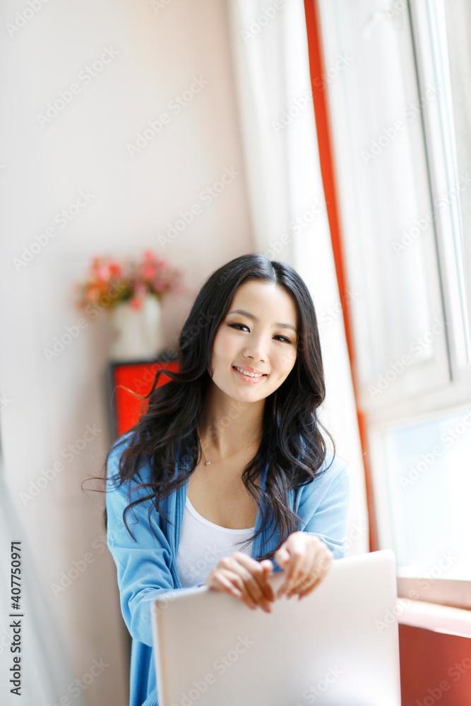 Fashion young woman using a laptop computer