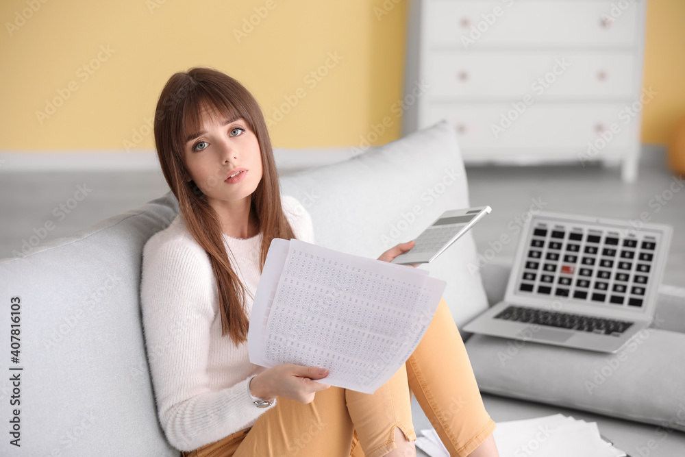 Stressed young woman trying to meet deadline at home