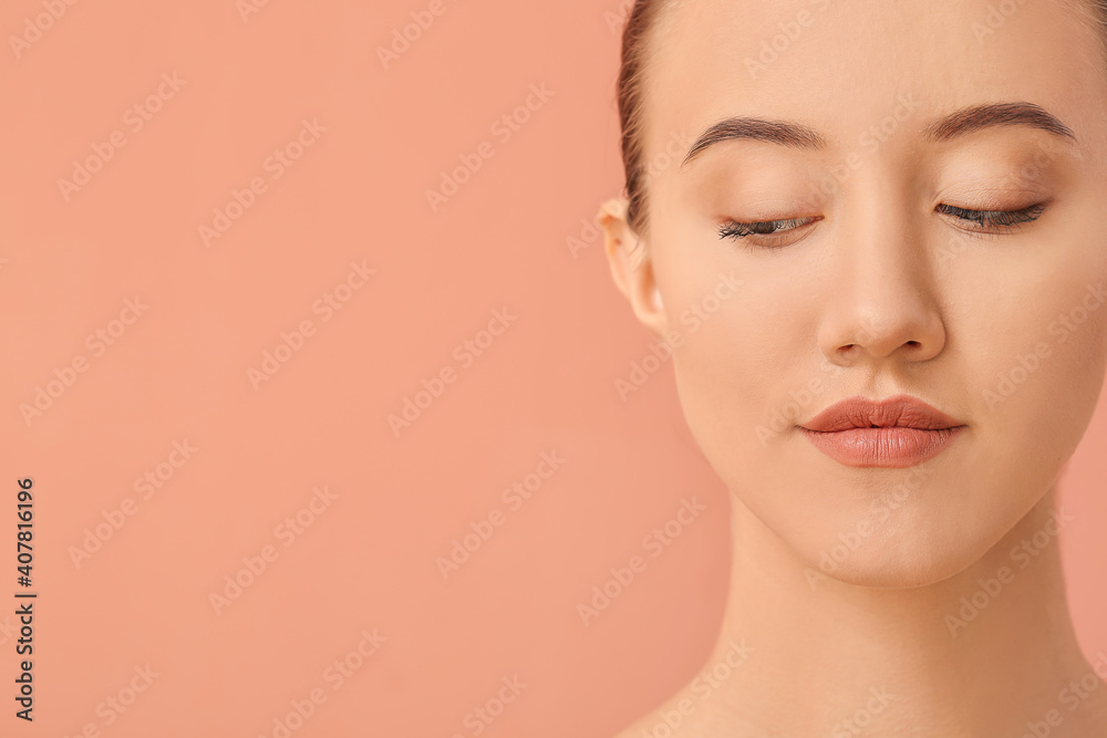 Portrait of beautiful young woman on color background