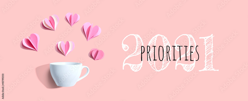 Priorities 2021 concept with a coffee cup and paper hearts - flat lay