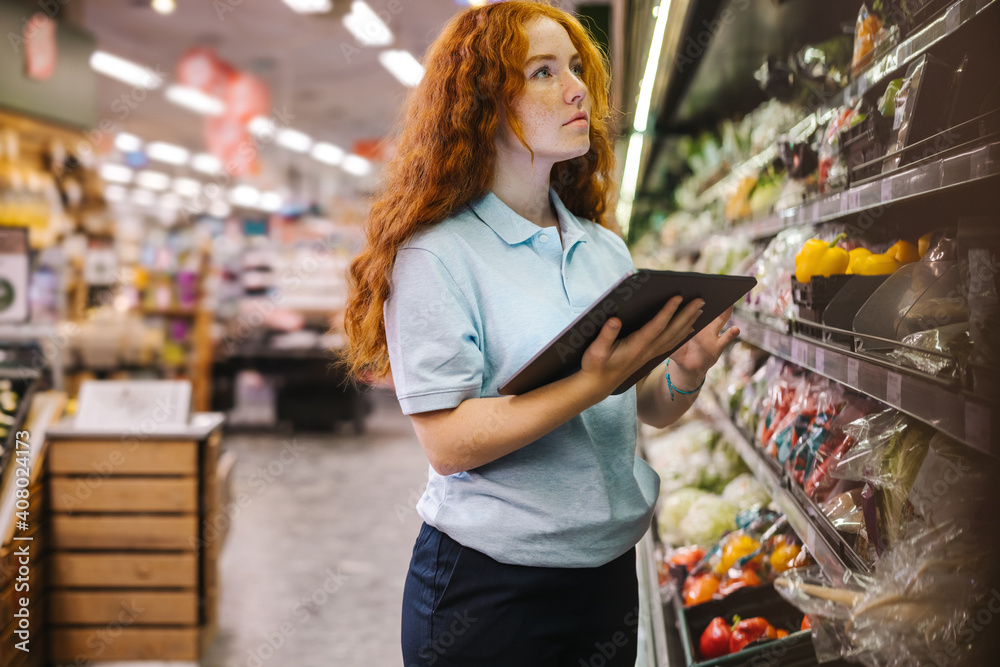 Grocery store employee taking inventory