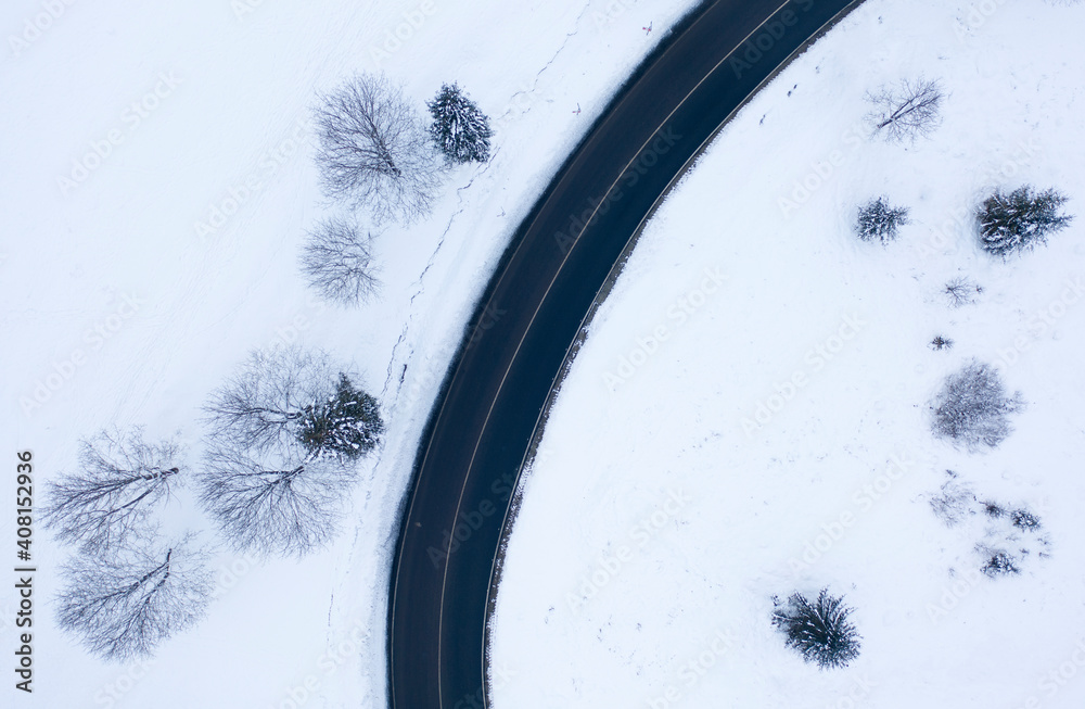 Mountain road in the winter forest. Dolomites Alps Italy.