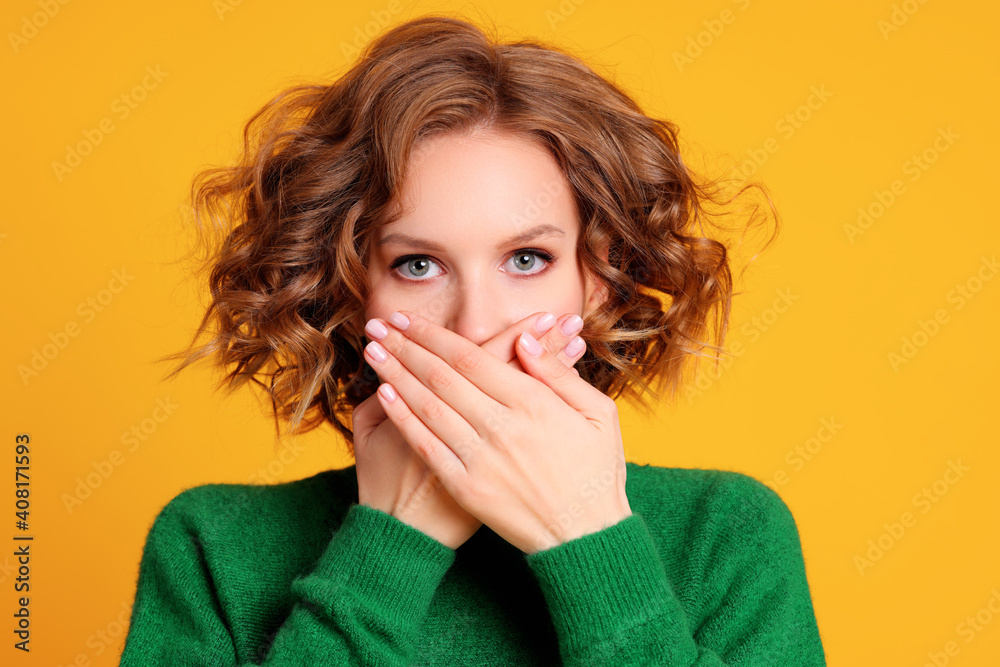 Shocked young female covering mouth