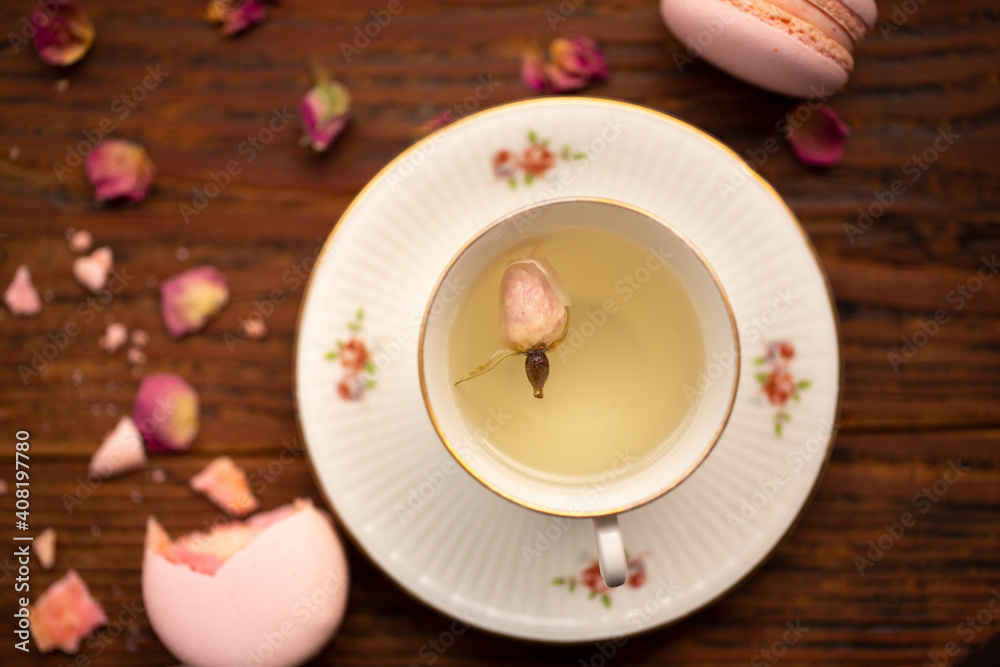 Cup of pink rose tea top view on table