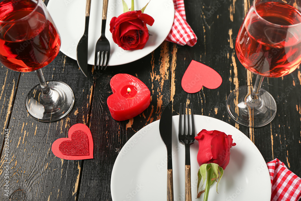 Festive table setting for Valentines Day celebration on dark wooden background