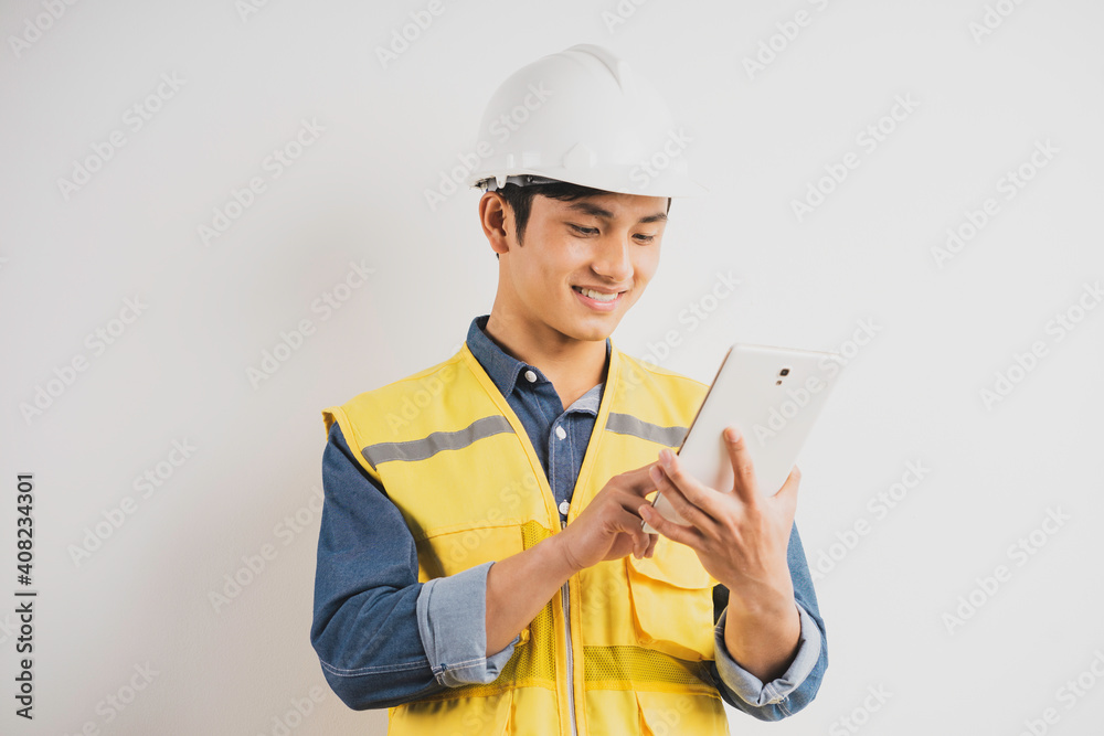 Asian construction engineer reading the technical drawing