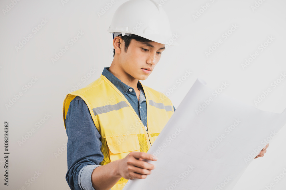 Asian construction engineer reading the technical drawing