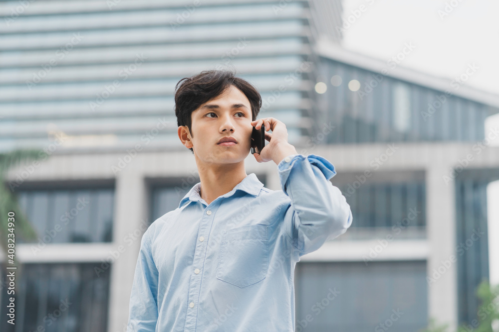 Asian businessman is calling outside