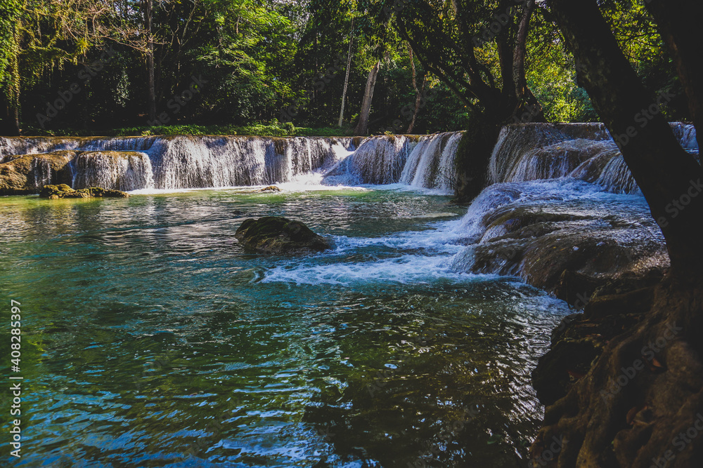 Deep forest waterfall stream view. Forest waterfall creek. Waterfall in deep forest. Waterfall river