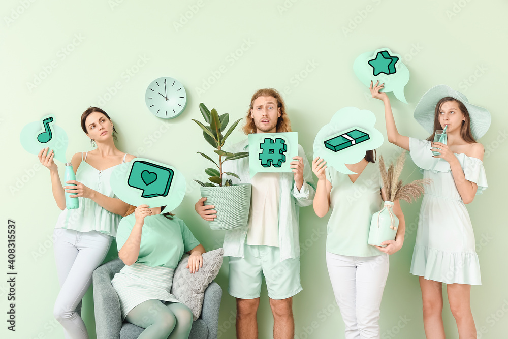 Group of young people holding speech bubbles with different drawings on color background