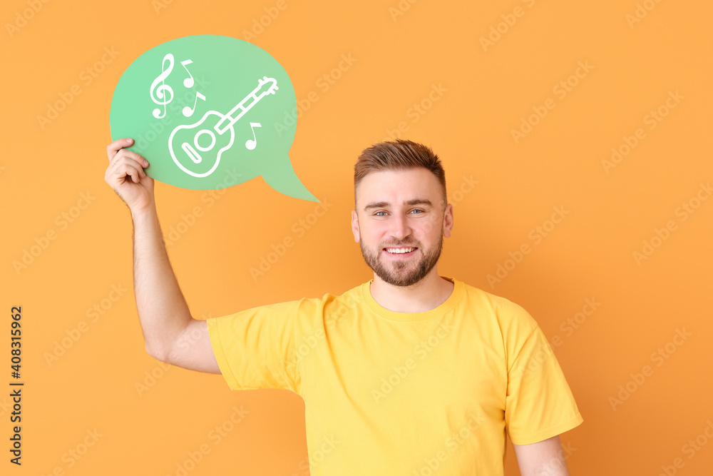 Man holding speech bubble with drawn guitar on color background