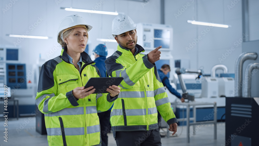 Chief Engineer and Project Supervisor in Safety Vests and Hard Hats Walk Through Modern Factory, Tal