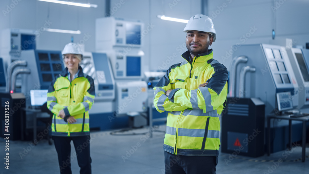 Portrait of Handsome Indian Engineer Wearing Safety Vest and Hardhat Crosses Arms and Smiles. Profes