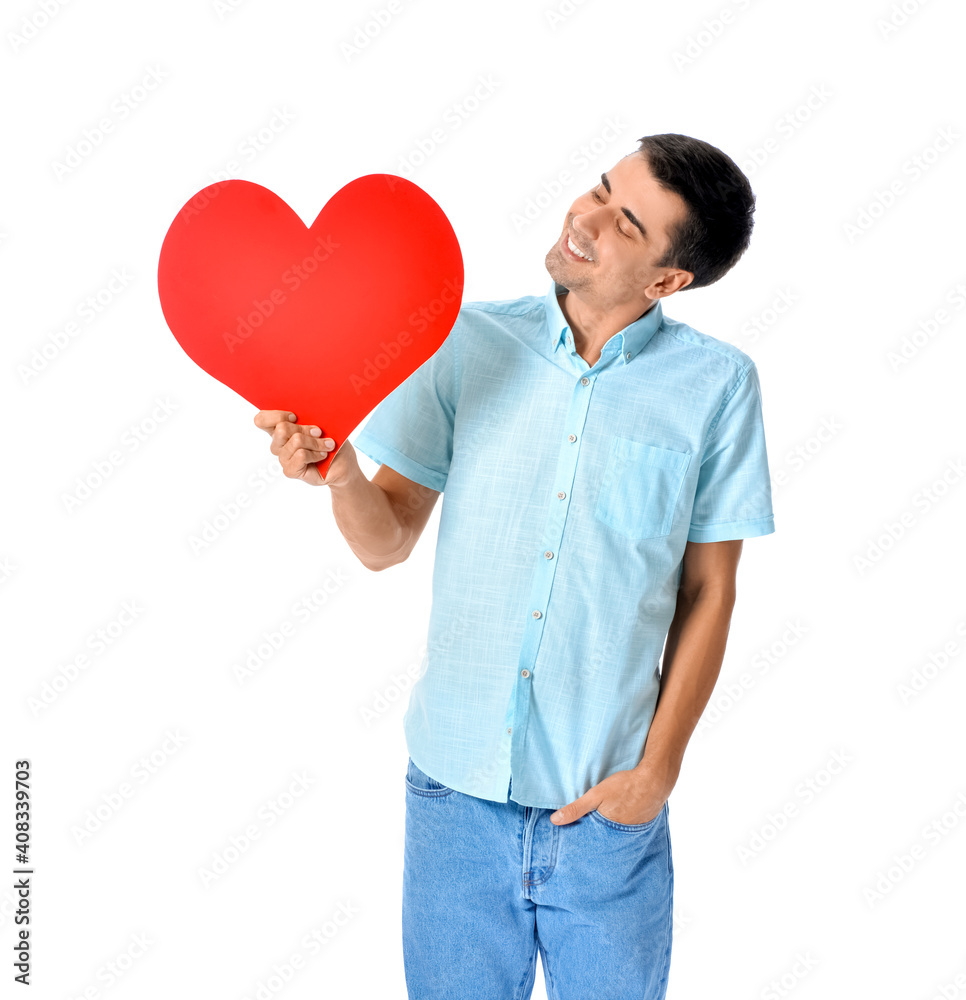 Handsome man with big red heart on white background